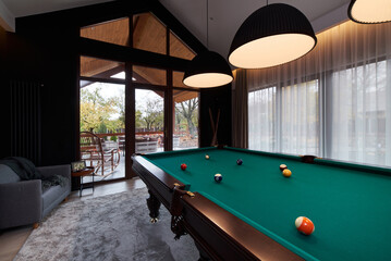 Wall Mural - modern billiard room with a beautiful table and large windows