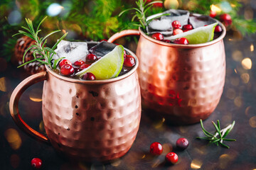 Wall Mural - Moscow Mule cocktail with cranberries in copper mugs for Christmas