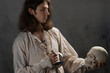 A romantic young man in a medieval costume with a sword says a Shakespearean monologue.