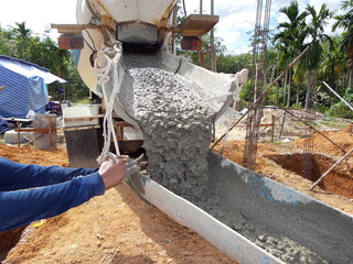 Construction work.Placing concrete foundations. Pouring concrete. Precast concrete products.