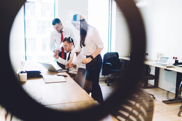 Wall Mural - Focused diverse employees discussing project together in office