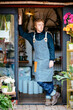 © Trinette Reed/Stocksy - Flower shop owner in storefront