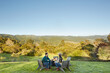 © Trinette Reed/Stocksy - Couple sitting at outdoor fire pit