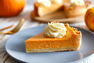 Wall Mural - Traditional thanksgiving food on wooden table. Orange delicious homemade pumpkin pie with crust and decorative items. Thanksgiving table setting concept.Top view, close up, copy space, background.