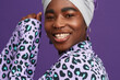 © Leandro Crespi Studio/Stocksy - Happy woman in headwrap and animal print