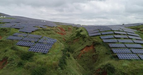 Wall Mural - Aerial Photography of a Photovoltaic Power Plant on Lush Hillside