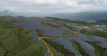 Wall Mural - Aerial Photography of a Photovoltaic Power Plant on Lush Hillside