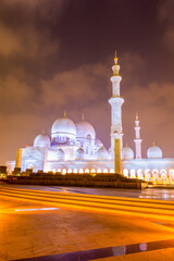 Wall Mural - Night view of Grand Mosque, also called Sheikh Zayed Grand Mosque in Abu Dhabi, United Arab Emirates, a very popular touristic site.