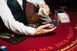 Croupier hands dealing cards on t blackjack poker table, gambling table with cards and chips
