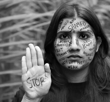 Black And White Photo Of A Southeast Asian Brown Woman Anti Gender Based Violence Messages Written All Of Her Face Protesting Against Violence Against Women And Girls And Saying To Stop Violence 