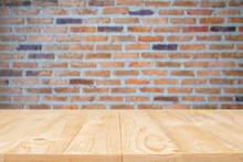 Close-up Of Wooden Table Against Brick Wall