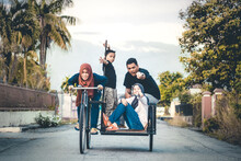 Family Gesturing While Traveling In Pedicab On Street Against Sky