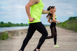 © Georgii - Running athletic couple in stylish sportswear on workout outdoors, healthy sport lifestyle