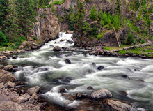 Long Time Exposure Of Flowing Water At Firehole River Yellowstone National Park On A Cloudy Summer Day