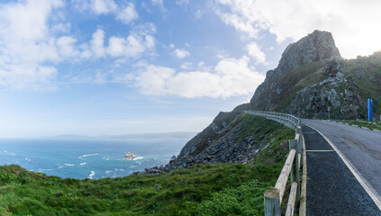 Poster - narrow road leading along tall cliffs on a wild ocean coast