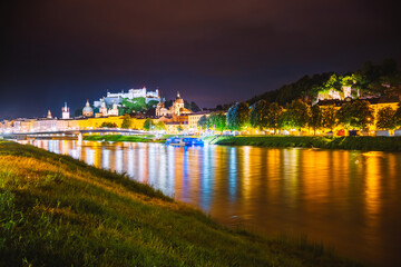 Fototapete - Salzburg city shining in the lights at night. Location place Salzburger Land, Austria, Europe.