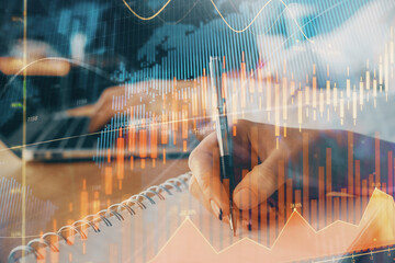 Double exposure of forex chart drawing over people taking notes background. Concept of financial analysis