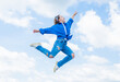 © be free - teen girl wearing casual fashion clothes jumping high on sky background, energy