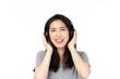 © ueaphan - Beautiful young asian woman joyful listening to music on headphones isolated on white background studio portrait.