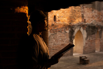 Muslim teacher or father teach Koran in old mosque