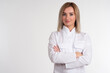 © Grispb - Portrait of a blonde in a white coat. Girl in a white uniform. Woman on a light background looks into the camera. Concept - a woman works in the field of cosmetology or medicine. Businesswoman