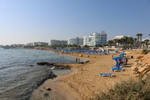 Relax On The Beach Under Blue Umbrellas In Cyprus Protaras