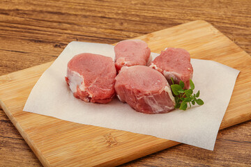 Raw pork medallion served rosemary