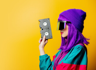 Wall Mural - Style woman in VR glasses and 80s tracksuit with audio tape