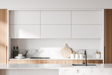 White and wooden kitchen with cupboards, close up