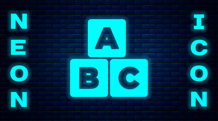 Glowing neon ABC blocks icon isolated on brick wall background. Alphabet cubes with letters A,B,C. Vector.