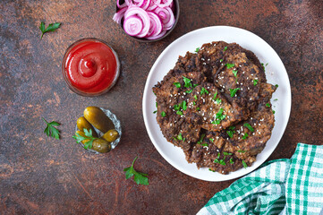 Wall Mural - Fried liver pieces with tomato sauce, pickled onions and cucumbers. Delicious healthy dish. Top view.