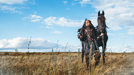 Wall Mural - Knight woman in armor with a horse against the sunset fields background