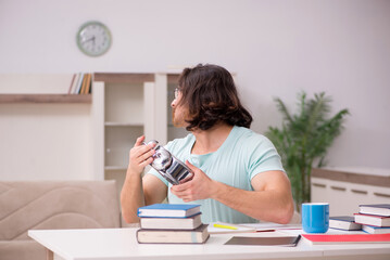 Young male student preparing for exams at home