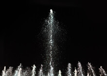 Water Fountain On A Dark Background. Jet And Spray In Motion.