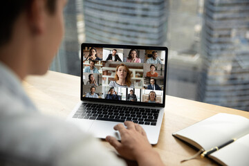 Wall Mural - shoulder back view female businesswoman looking at laptop screen, briefing discussing working issues