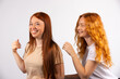 © Viorel - Two red-haired girlfriends are having fun. Photo on a white background.