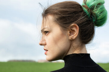 Girl with green hair on field with sky