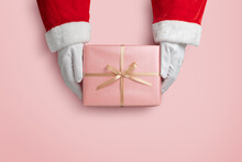 Top View Of Santa Claus Hands Is Holding A Pink Gift Box