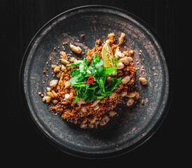 Wall Mural - Fried rice with beef meat and vegetables in plate on black wooden table background