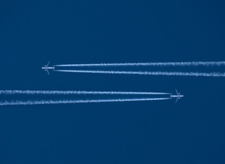 Wall Mural - Airplane in the sky with a trace of steam contrail.Airliner.