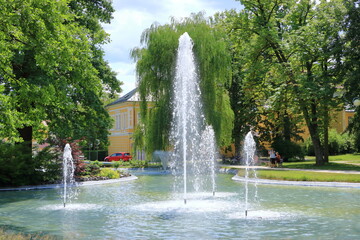 Wall Mural - Iron fountain in the middle of the lake, water splash