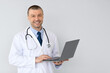 © Prostock-studio - Portrait of male medical practitioner holding laptop