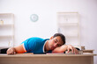 © Elnur - Exhausted male student preparing for the exams in the classroom