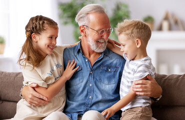 Sticker - Grandfather hugging grandchildren on sofa.