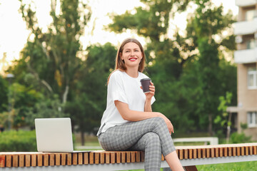 Sticker - Beautiful young businesswoman relaxing in park