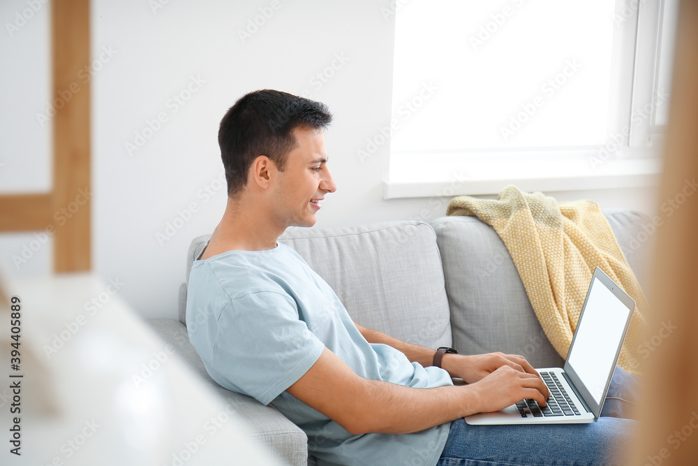 Young man working on laptop at home