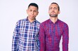 © Krakenimages.com - Young gay couple of two men wearing casual clothes puffing cheeks with funny face. mouth inflated with air, crazy expression.