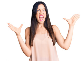 Young beautiful caucasian woman wearing casual clothes crazy and mad shouting and yelling with aggressive expression and arms raised. frustration concept.