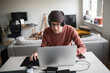 © Johnér - Man with headphones using laptop, Sweden