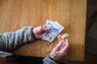 © Johnér - Hands holding banknotes and coins, Sweden